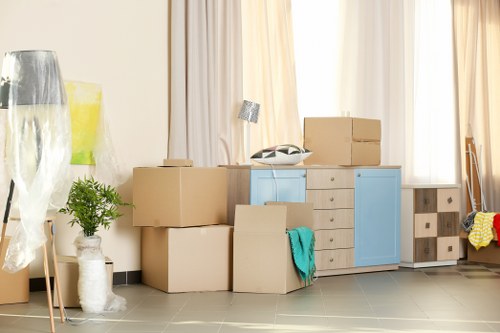Removal van and moving team in a residential Catford street