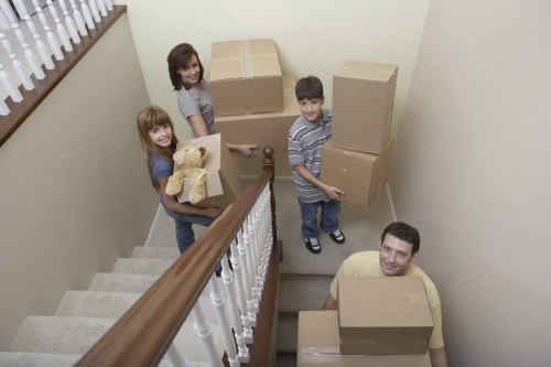 Loading household boxes and furniture into a removals van in Catford